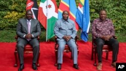 Kenya's President William Ruto, left, Burundi's President and summit chairperson Evariste Ndayishimiye, center, and Kenya's former President and summit facilitator Uhuru Kenyatta pose for a photo ahead of their meeting at a hotel in Nairobi, Kenya, Nov. 28, 2022.