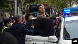 Police detain a protester during a demonstration on a street in Shanghai, China, on Nov. 27, 2022.