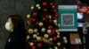 A QR code for the "LeaveHomeSafe" COVID-19 contact-tracing app is seen inside a shopping mall in Hong Kong, China, Dec 13, 202