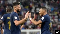 Olivier Giroud (a goch) ak Kylian Mbappe, selebre gol yo make pandan match seleksyon nasyonal La Frans kon Poloy, 4 Desanm, 2022. 