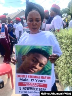 Nambazira Sauda holds a poster of her 17-year-old son, who was abducted from Masunafu in Uganda, on Nov. 5, 2022.