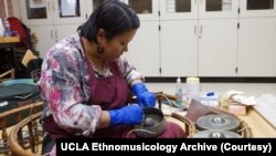 Supeena Insee Adler, a classical Thai musician, instrument repairer, and lecturer in ethnomusicology at UCLA, repairs a gong circle, known in Thai as a “Khong wong.”