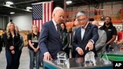 President Joe Biden tours SK Siltron CSS, a computer chip factory in Bay City, Mich., Tuesday, Nov. 29, 2022, with SK Siltron CSS CEO Jianwei Dong.