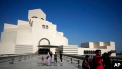 People walk outside the Museum of Islamic Art in Doha, Qatar, Nov. 22, 2022.