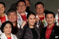 The daughter of Thailand's former Prime Minister Thaksin Shinawatra, Paetongtarn Shinawatra cheers with supporters during a Pheu Thai party general assembly meeting in Bangkok, Thailand, Tuesday, Dec. 6, 2022.