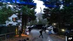 The access road to President Joe Biden's home in Wilmington, Del., is seen from the media van Friday, Jan. 13, 2023. (AP Photo/Carolyn Kaster)