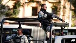 Security personnel guard the prosecutor's building where Ovidio Guzman, one of the sons of former Sinaloa cartel boss Joaquin "El Chapo" Guzman, is in custody in Mexico City, Jan. 5, 2023. 