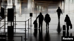 People walk in the departures hall at Beijing Capital International Airport after China lifted the COVID-19 quarantine requirement for inbound travelers, Jan. 8, 2023.