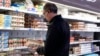 A shopper checks eggs before he purchases at a grocery store in Glenview, Ill., Jan. 10, 2023.