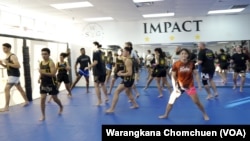 Stamp Fairtex, Thai female fighter, warms up before teaching Muay Thai techniques at a seminar at Impact Martial Arts Academy in Virginia, October, 2022.