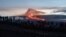 People gather to observe the eruption of the Mauna Loa volcano in Hawaii, Dec. 1, 2022.