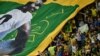 A large flag of Brazil legend Pele is unveiled in the crowd ahead of the Qatar 2022 World Cup Group G football match between Cameroon and Brazil at the Lusail Stadium in Lusail, north of Doha on Dec. 2, 2022