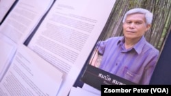 A pamphlet about Sombath Somphone sits on display at an event in Bangkok, Thailand, Dec. 15, 2022, marking the 10-year anniversary of his enforced disappearance in Laos. 