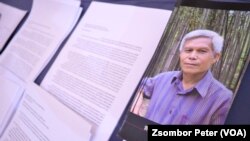 A pamphlet about Sombath Somphone sits on display at an event in Bangkok, Thailand, Dec. 15, 2022, marking the 10-year anniversary of his enforced disappearance in Laos. 