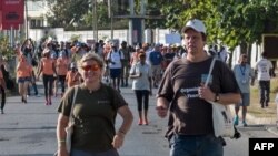 A picture taken on January 14, 2017, shows South African conservationist Wayne Lotter (R) and Krissie Clark, co-founders of the PAMS foundation, taking part in the Walk for Elephants event endorsed by the Chinese embassy, in Dar es Salaam.