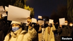 北京民众手举白纸上街游行，抗议中国严厉的防疫政策，悼念乌鲁木齐火灾死难者。（2022年11月27日）