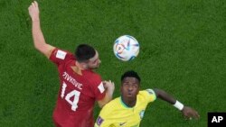 Brazil's Vinicius Junior, right, and Serbia's Andrija Zivkovic vie for the ball during their World Cup group G soccer match at the Lusail Stadium in Lusail, Qatar, Nov. 24, 2022.