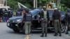 FILE - Police officers stop a vehicle at a checkpoint in Abuja, Nigeria, Oct. 21, 2021. A women and her unborn child were shot and killed Sunday after an officer opened fire at her family’s vehicle at a checkpoint in Ajah. The circumstances remain unclear.