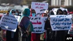 Women hold placards during a protest calling for their rights to be recognized, near the Shah-e-Do Shamshira mosque in Kabul, Nov. 24, 2022. Afghan women have been squeezed out of public life since the Taliban's return to power in August 2022.