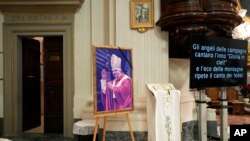 A photo of late Pope Emeritus Benedict XVI is displayed in the San Tommaso Da Villanova Parrish church in Castel Gandolfo, in the hills south of Rome, Italy, Jan. 3, 2023.