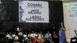 FILE: Malian nationals and young Ivorians gather to demand the release of 46 Ivorian soldiers being held by authorities in Mali, in the Abobo suburb of Abidjan, Ivory Coast, on Sept. 20, 2022. 