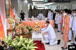 Thai Prime Minister Prayut Chan-O-Cha, center, offers flowers for the health of Princess Bajrakitiyabha Narendira Debyavati, at Chulalongkorn Hospital in Bangkok, Dec. 16, 2022.