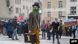 Young Socialists Switzerland (JUSO) activists take part in a protest against the World Economic Forum (WEF), calling for a climate tax on the rich, on the eve of the WEF annual meeting in Davos.