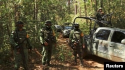 FILE - Soldiers keep watch at an area where the military eradicated a coca leaf plantation and dismantled a lab to process the drug in Guerrero state, Mexico, Feb. 22, 2021. Guerrero is one of Mexico's most violent regions and where three journalists disappeared in late 2022. 