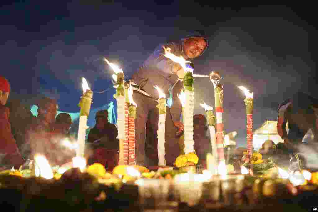 A devotee lights an oil lamp during the Bala Chaturdashi festival at the Pashupatinath Hindu temple in Kathmandu, Nepal, Monday, Nov. 21, 2022.