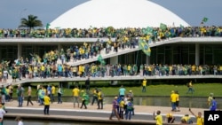 Supporters of Brazil's former President Jair Bolsonaro storm the the National Congress building in Brasilia, Brazil, Jan. 8, 2023.