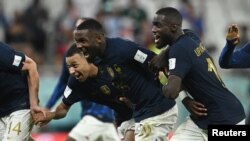 FILE: France's Kylian Mbappe (Left), Marcus Thuram (center) and Dayot Upamecano (right) celebrate after the match as France progress to the quarter finals on December 4, 2022 