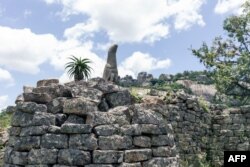 A sculpture of a bird carved from soapstone was temporarily moved from a museum at the same site to be placed back in its original position at the Great Zimbabwe monument near Masvingo on February 20, 2020