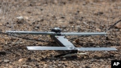 FILE - This image provided by the U.S. Marine Corps, shows a Switchblade drone system being used as part of a training exercise at Marine Corps Air Ground Combat Center Twentynine Palms, California, Sept. 24, 2021.