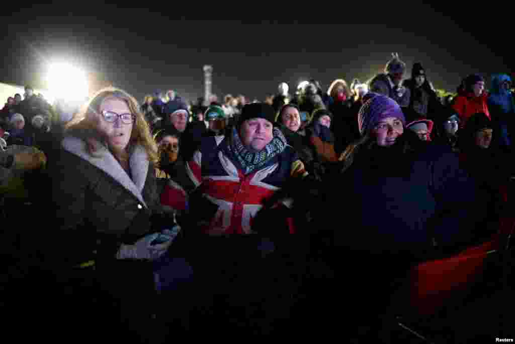People watch Britain&#39;s first satellite launch, on a TV screen at Cornwall Airport Newquay, in Cornwall, Britain, Jan. 9, 2023.