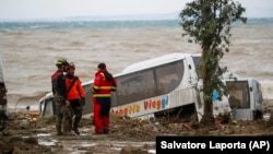 Equipas de resgate junto a um autocarro que foi levado pelo deslizamento de terra em Casamicciola, ilha italiana de Ischia. 26 novembro, 2022