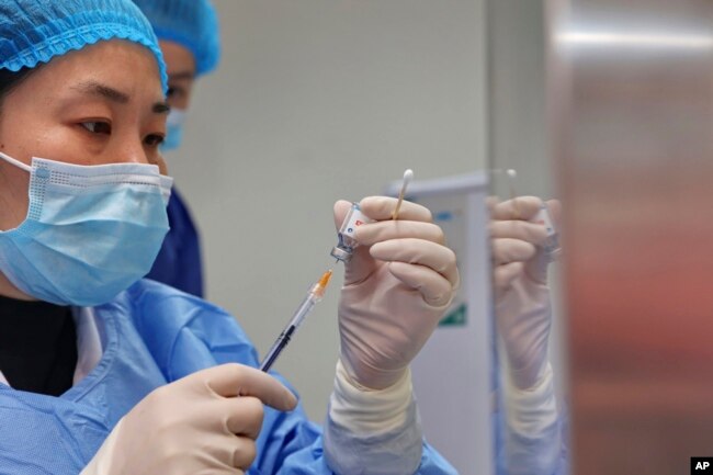 A nurse prepares a shot of COVID-19 vaccine at a community health center in Nantong in eastern China's Jiangsu province on Dec. 9, 2022. (Chinatopix Via AP)