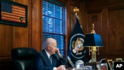 FILE - In this file image provided by The White House, President Joe Biden speaks with Russian President Vladimir Putin on the phone from his private residence in Wilmington, Del., Dec. 30, 2021.