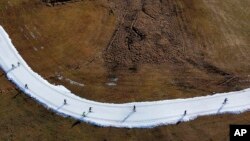 People ski on a cross country slope in Ramsau, Austria, Jan. 6, 2023.