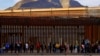 FILE - After crossing the Rio Bravo River, migrants queue near U.S.-Mexico border fence to request asylum in El Paso, Texas, Jan. 5, 2023. 