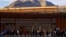 Migrants queue near the border fence, after crossing the Rio Bravo river, to request asylum in El Paso, Texas, as seen from Ciudad Juarez, Mexico, Jan. 5, 2023. 