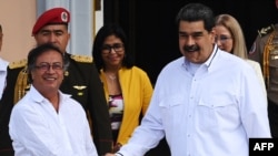 Venezuelan President Nicolas Maduro, right, and his Colombian counterpart, Gustavo Petro, shake hands before a private meeting at the Miraflores presidential palace in Caracas, Venezuela, Jan. 7, 2023. 