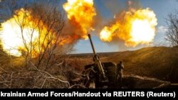 FILE: Ukrainian servicemen fire a 130 mm towed field gun M-46 on a front line, as Russia's attack on Ukraine continues, near Soledar, Donetsk region, Ukraine. Taken November 10, 2022