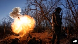 Ukrainian servicemen fire a 120mm mortar towards Russian positions at the front line near Bakhmut, Donetsk region, Ukraine, Jan. 11, 2023. 