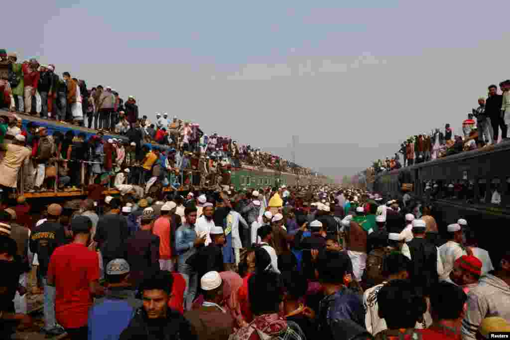 Devotees climb on the rooftop of an overcrowded train to return home, after attending the final prayer of Bishwa Ijtema, which is considered the world&rsquo;s second-largest Muslim gathering after Haj, in Tongi, outskirts of Dhaka, Bangladesh.&nbsp;