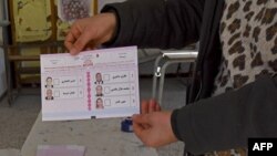 A ballot is displayed at a polling station in Mnihla district, outside of Tunis on December 17, 2022, during the parliamentary election.