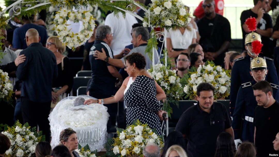 Pele's daughter, Kelly Cristina Nascimento, is seen next to the body of Brazilian soccer legend Pele in his casket, as he lays in state on the pitch of his former club Santos' Vila Belmiro Stadium in Santos, Jan. 2, 2023.