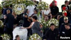 Pele's daughter, Kelly Cristina Nascimento, is seen next to the body of Brazilian soccer legend Pele in his casket, as he lays in state on the pitch of his former club Santos' Vila Belmiro Stadium in Santos, Jan. 2, 2023.