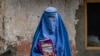 FILE - Arefeh, 40, an Afghan woman, leaves an underground school in Kabul, July 30, 2022. She attends this school with her daughter, who like other teenage girls is not allowed to go to public school.