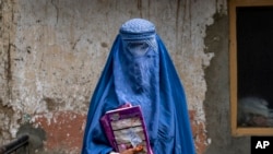 FILE - Arefeh, 40, an Afghan woman, leaves an underground school in Kabul, July 30, 2022. She attends this school with her daughter, who like other teenage girls is not allowed to go to public school.