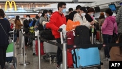 Passengers queue to check-in at the international airport in Hong Kong on Dec. 28, 2022. 